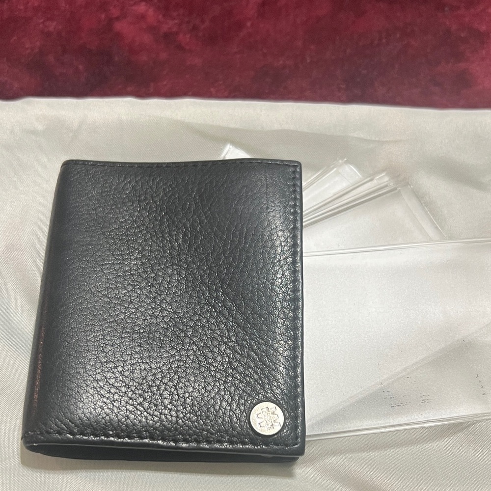 Black Leather Wallet by Wilson leather. Has sleeves for photos or cards